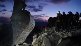 Rescuers with construction equipment at earthquake site in Northern Syria