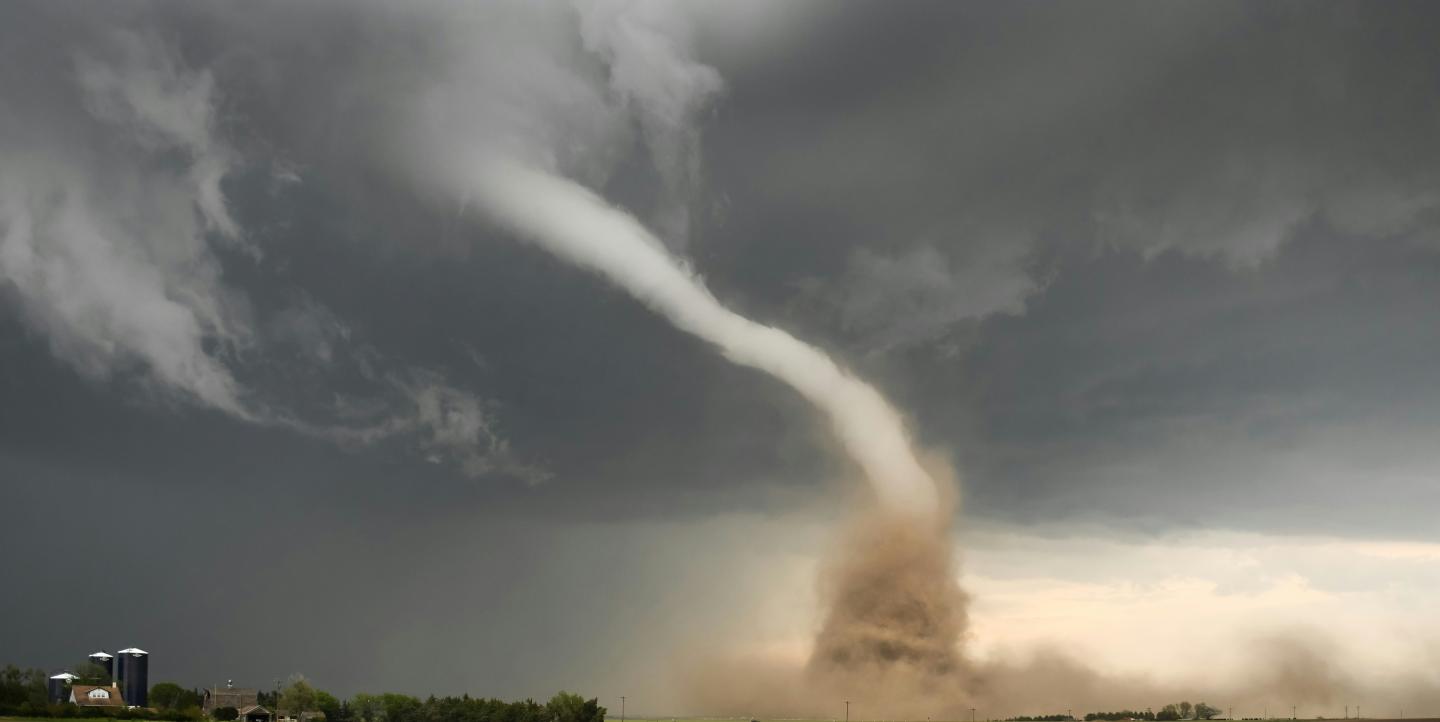 A large tornado coming out of the sky.
