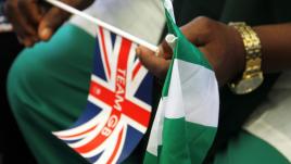 Man holding a UK and a Nigerian flag