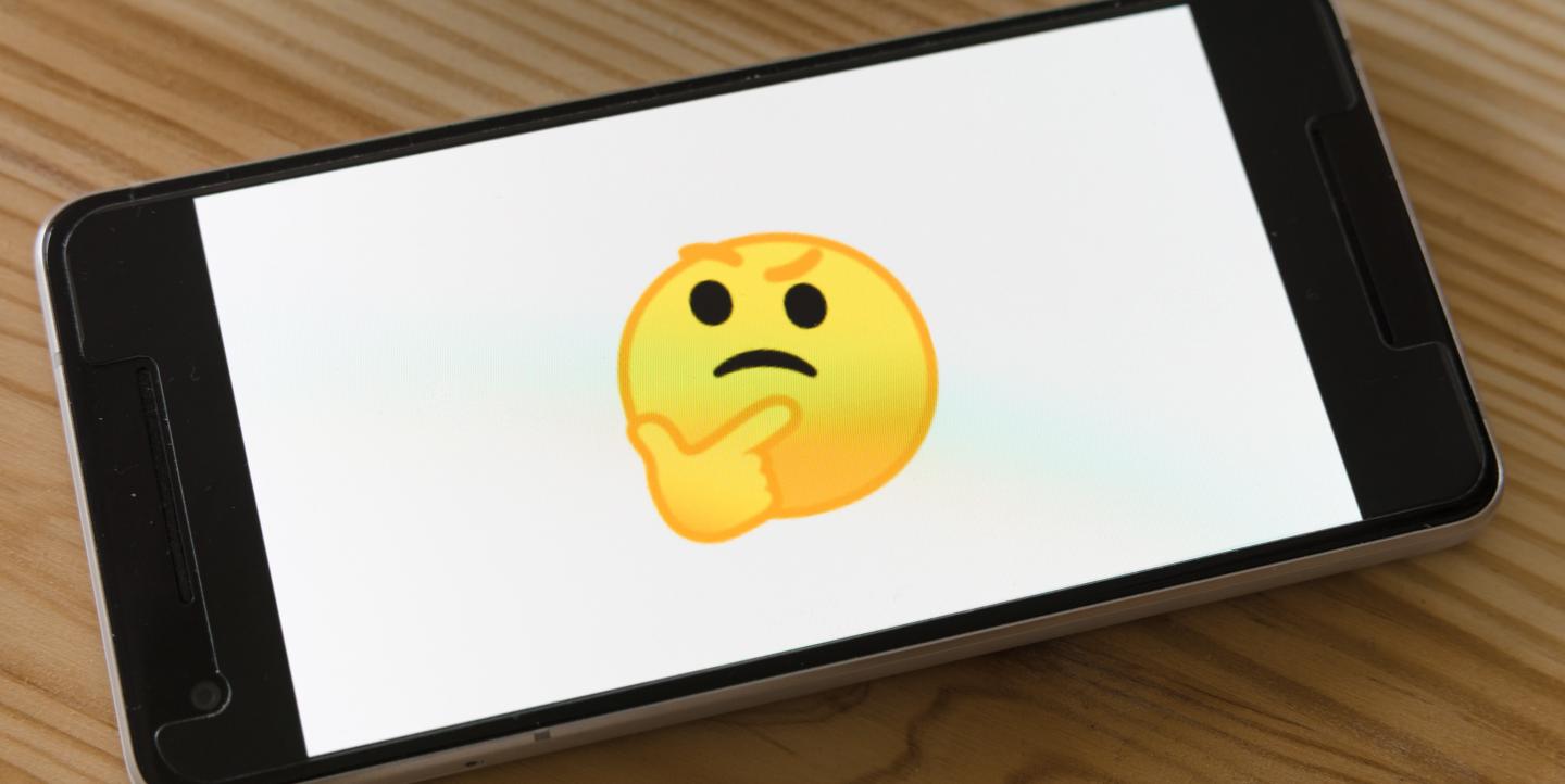 Thinking emoji on a black phone