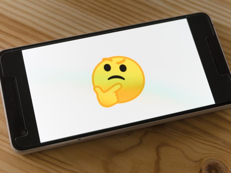 Thinking emoji on a black phone
