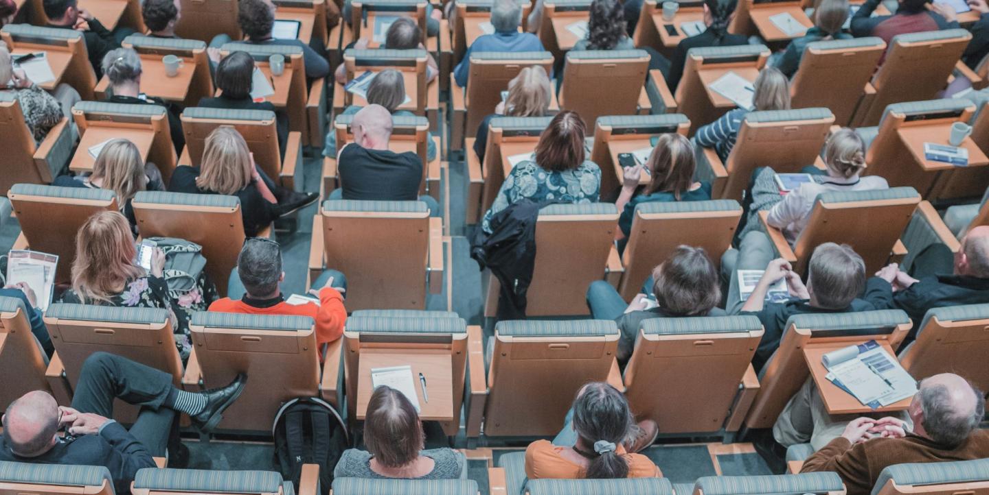 People sitting in chairs at a conference