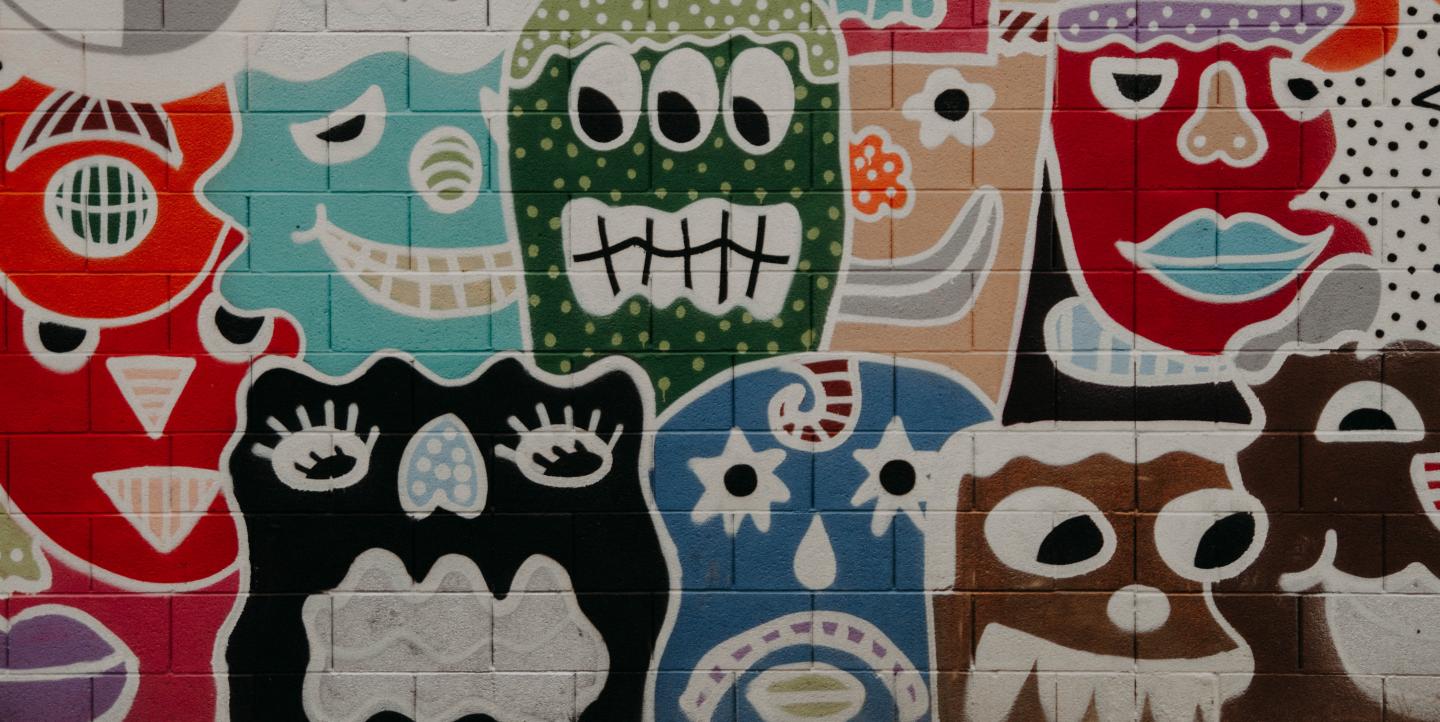 Painted cartoon faces showing different emotions