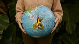 Woman holding globe on fire