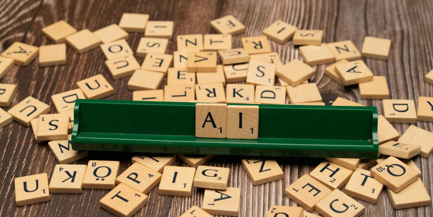 Scrabble pieces that spell AI.