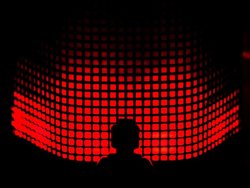 Robot in front of a red background